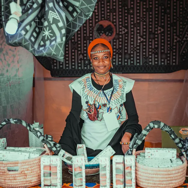 A seller at her stall of woven baskets and printed fabrics